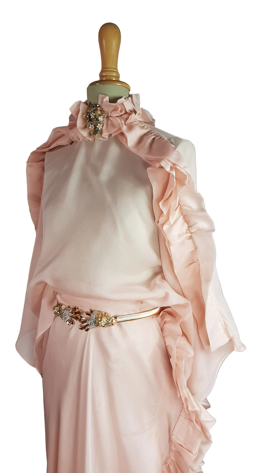 Pink dress with ruffled details on a mannequin against a neutral background