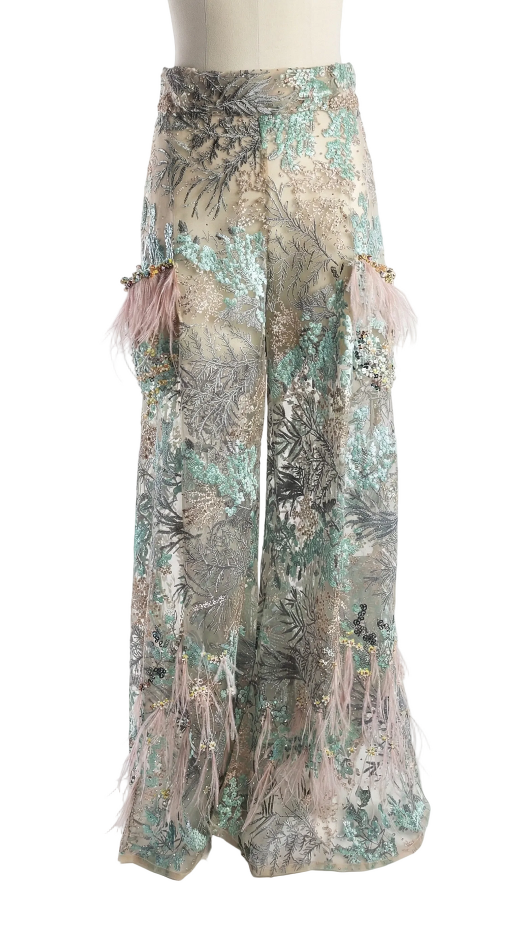 Floral patterned pants with tassels on a white background