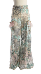 Floral patterned pants with tassels on a white background