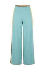 Light blue pants with yellow trim on a beige background